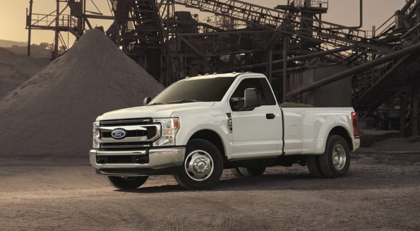 A white 2022 Ford F-350 is shown from the side parked at a construction site after winning a 2022 Ford F-350 vs 2022 GMC Sierra 3500HD comparison.