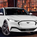 A white 2022 Ford Mustang Mach-E is shown from the front.