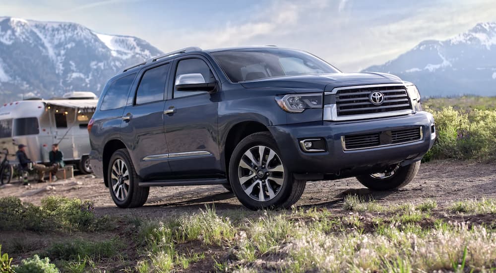 A blue 2022 Toyota Sequoia Limited is shown from the side parked in the mountains.