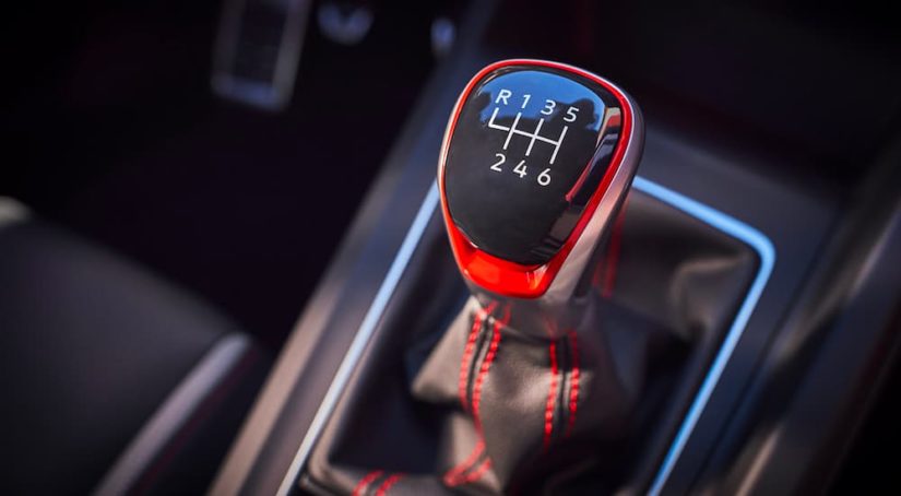 A close up shows the manual shift knob in a 2022 Volkswagen Golf GTI.