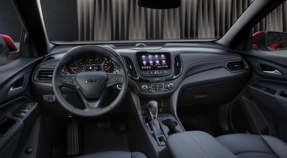 The black interior of a 2022 Chevy Equinox RS is shown at a Chevy Equinox dealership.
