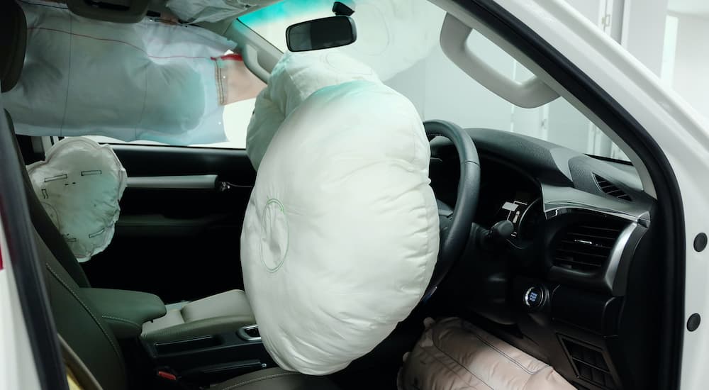 The airbags are shown inflated during a side crash safety test.