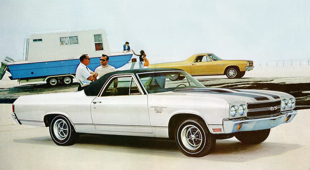 A white 1970 Chevy El Camino SS1 is shown from the side parked at a beach after leaving a used Chevy dealership.