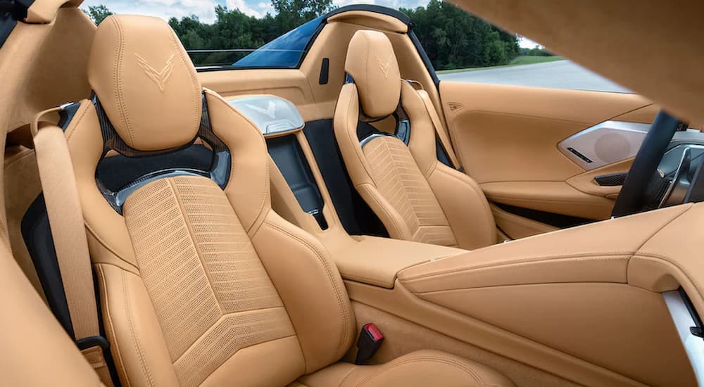 The tan interior of a 2022 Chevy Corvette Stingray 3LT shows the front seats.