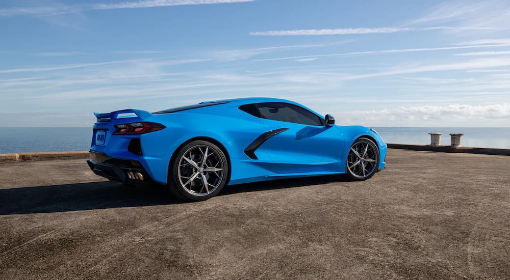A blue 2022 Chevy Corvette Stingray 1LT is shown from the side in an empty lot.