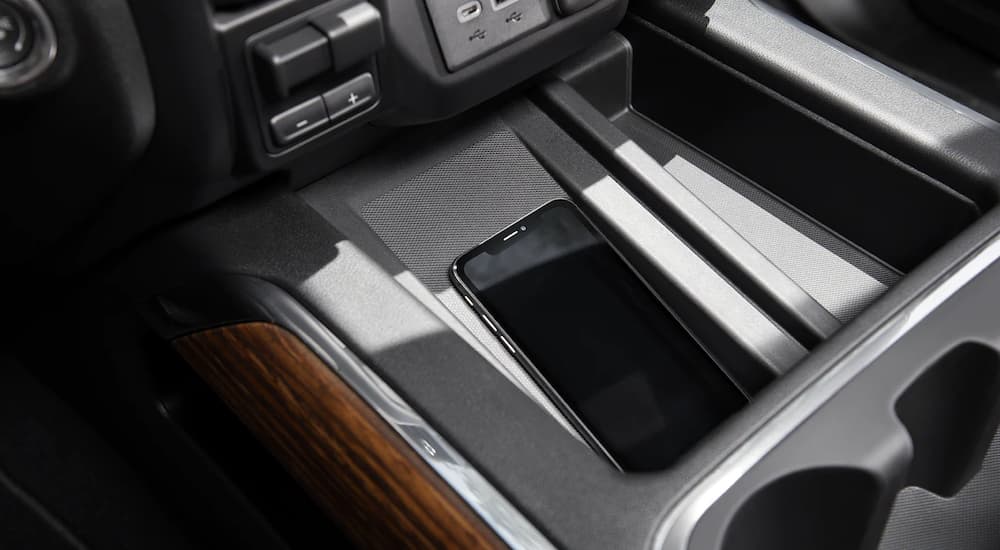 A phone using the wireless charging pad is shown in a 2022 Chevy Silverado 3500 HD.