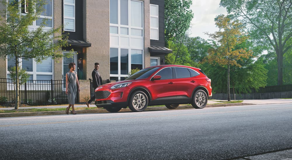 A red 2022 Ford Escape SE is shown parked on a city street.