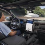 A woman is shown using the Blue Cruise feature in a 2022 Ford Expedition.