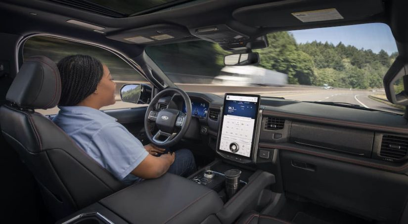 A woman is shown using the Blue Cruise feature in a 2022 Ford Expedition.