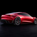 A red 2023 Tesla Roadster is shown from the rear parked against a black background.
