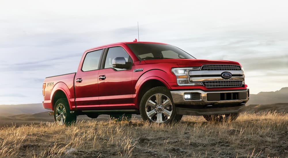 A red 2020 Ford F-150 is shown parked in a dry grassy field.