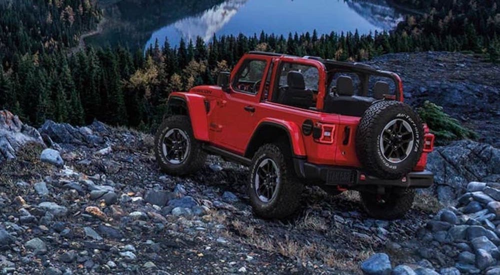 A red 2020 Jeep Wrangler is shown from the side parked in the mountains.