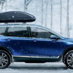 A popular Certified Pre-Owned car, a blue 2020 Honda CR-V Touring is shown from the side parked in the snow.