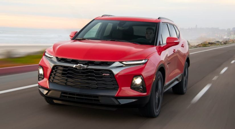 A red 2020 Chevy Blazer RS is shown from the front driving on an open road.