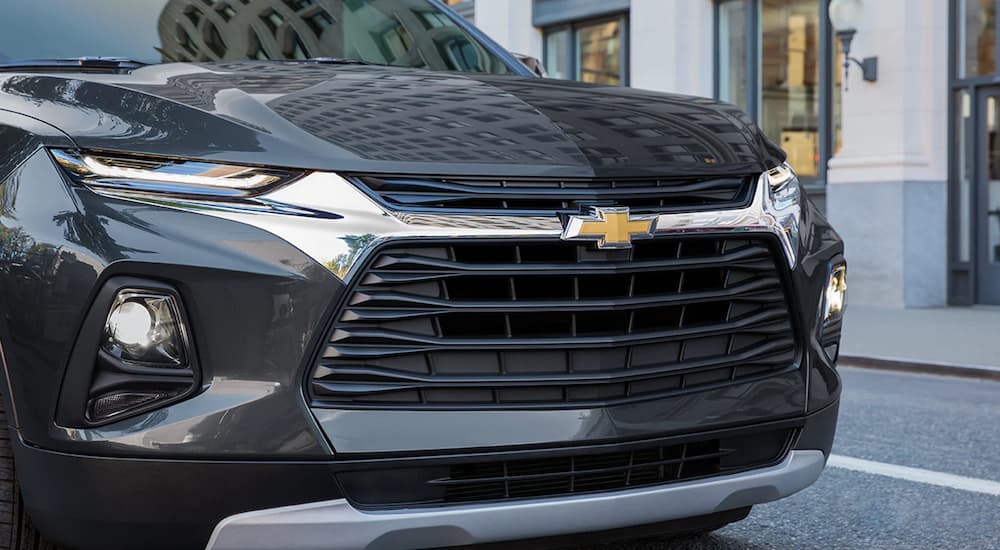 A close up shows the grille and headlights of a black 2022 Chevy Blazer.