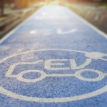 A blue electric vehicle parking space is shown.