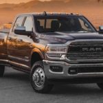 A black 2022 Ram 3500 is shown from the front parked on cement in front of a desert.