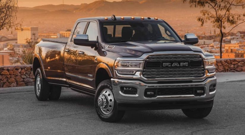 A black 2022 Ram 3500 is shown from the front parked on cement in front of a desert.