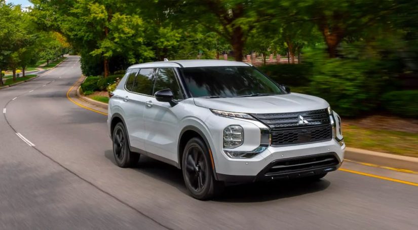 A silver 2023 Mitsubishi Outlander is shown on the way to check out SUVs for sale.