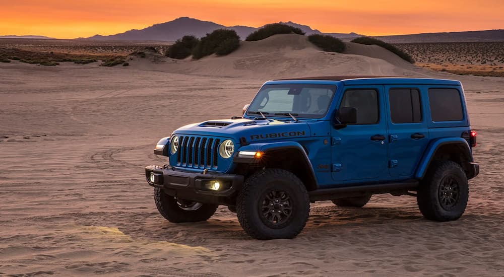 A blue 2021 Jeep Wrangler Rubicon 392 is shown parked in a desert.
