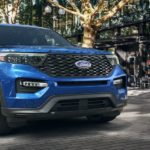 A blue 2022 Ford Explorer ST Atlas is shown parked outside of a restaurant.