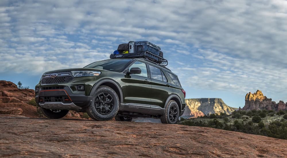 A green 2022 Ford Explorer Timberline is shown parked on a remote trail during a 2022 Ford Explorer vs 2022 GMC Acadia comparison.