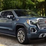 A blue 2022 GMC Sierra 1500 Denali is shown parked in a driveway after a 2022 GMC Sierra 1500 vs 2022 Toyota Tundra competition.