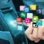 Apps are shown coming out of a car's infotainment system.