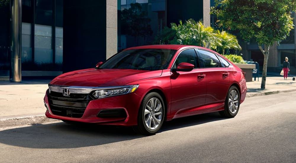 A red 2020 Honda Accord LX is shown parked on the side of a city street.