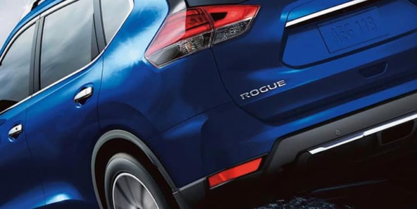 A close up shows the rear tire and bumper of a blue 2020 Nissan Rogue.