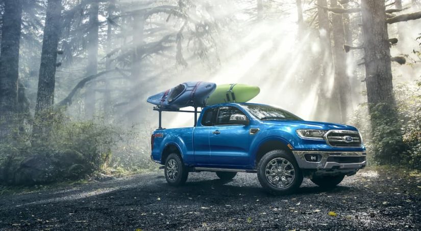 A blue 2022 Ford Ranger Lariat SuperCab is shown parked in the woods after leaving a Ford dealer.