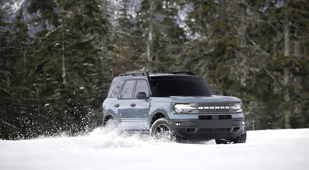 A grey 2022 Ford Bronco Sport is shown kicking up snow after being purchased through a Ford pre-order process.