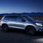 A silver 2020 Honda Passport Elite is shown parked near a desert campsite after leaving a Honda Passport dealer.