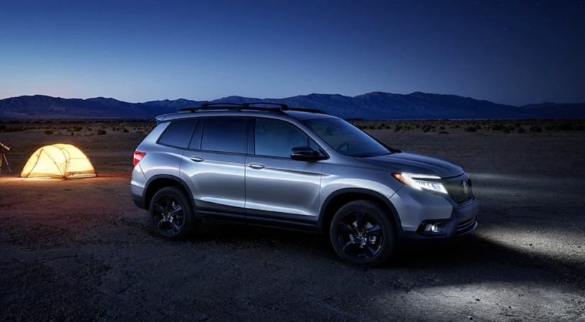 A silver 2020 Honda Passport Elite is shown parked near a desert campsite after leaving a Honda Passport dealer.