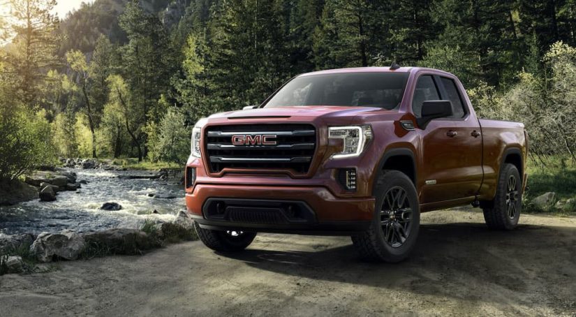 A red 2019 GMC Sierra 1500 Elevation is shown parked next to a river.