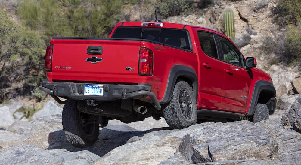A 2019 Chevy Colorado ZR2 Bison is shown crawling over rocks from behind.
