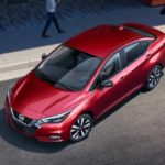 A red 2022 Nissan Versa is shown parking from a high angle after leaving a Nissan dealer near you.
