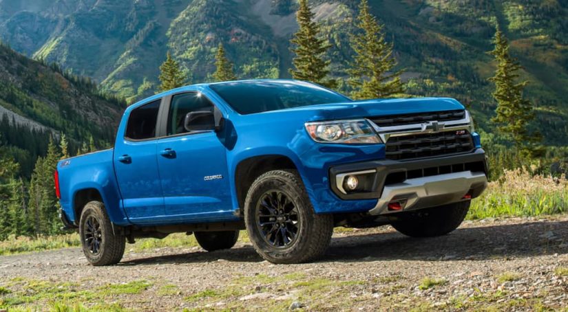 A blue 2022 Chevy Colorado Z71 is shown parked on a dirt path during a 2022 Chevy Colorado vs the 2022 Ford Ranger comparison.