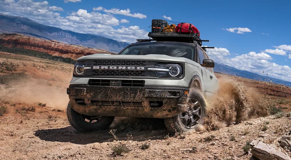 A grey 2022 Ford Bronco Sport Badlands is shown kicking up dirt in the desert.