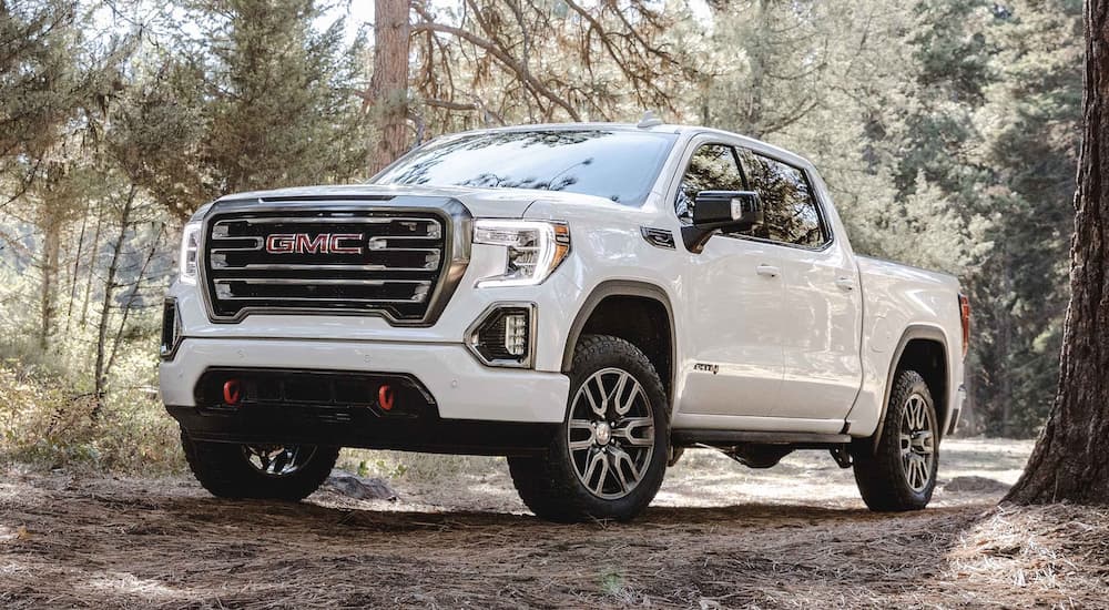 A white 2022 GMC Sierra 1500 ATX-4 is shown parked on a trail during a 2022 Ram 1500 vs 2022 GMC Sierra 1500 competition.
