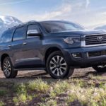 A grey 2022 Toyota Sequoia Limited is shown driving on a mountain trail.