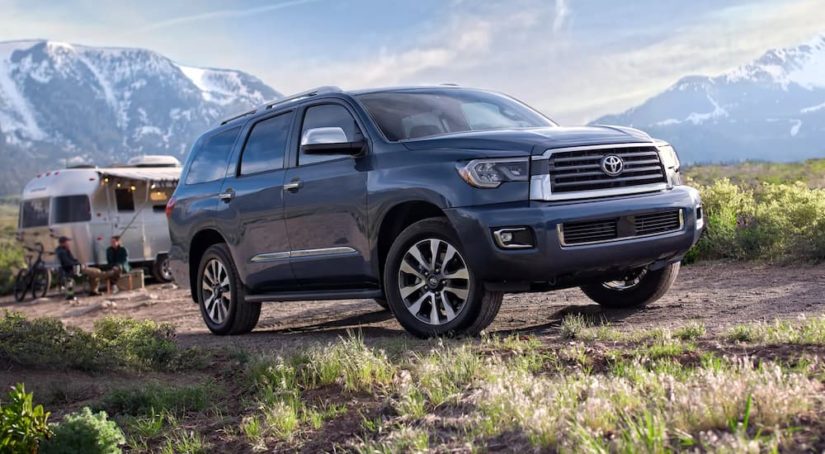 A grey 2022 Toyota Sequoia Limited is shown driving on a mountain trail.
