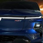A close up of the front of a blue 2024 Chevy Silverado EV is shown during a 2024 Chevy Silverado EV vs 2022 Ford F-150 Lightning competition.
