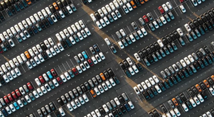 A lot of used cars is shown from a high view.