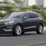 A blue 2021 Buick Avenir is shown leaving a pre-owned Buick dealer.