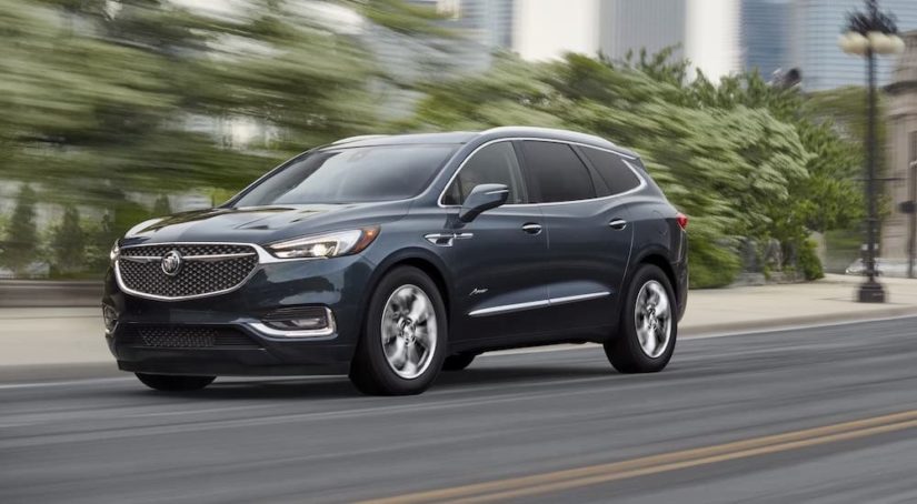 A blue 2021 Buick Avenir is shown leaving a pre-owned Buick dealer.