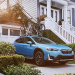 A blue 2022 Subaru Crosstrek Hybrid is shown parked in a driveway after visiting a Subaru Crosstrek dealer.