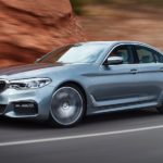 A silver 2017 BMW 5 Series is shown leaving a used BMW dealer near you.