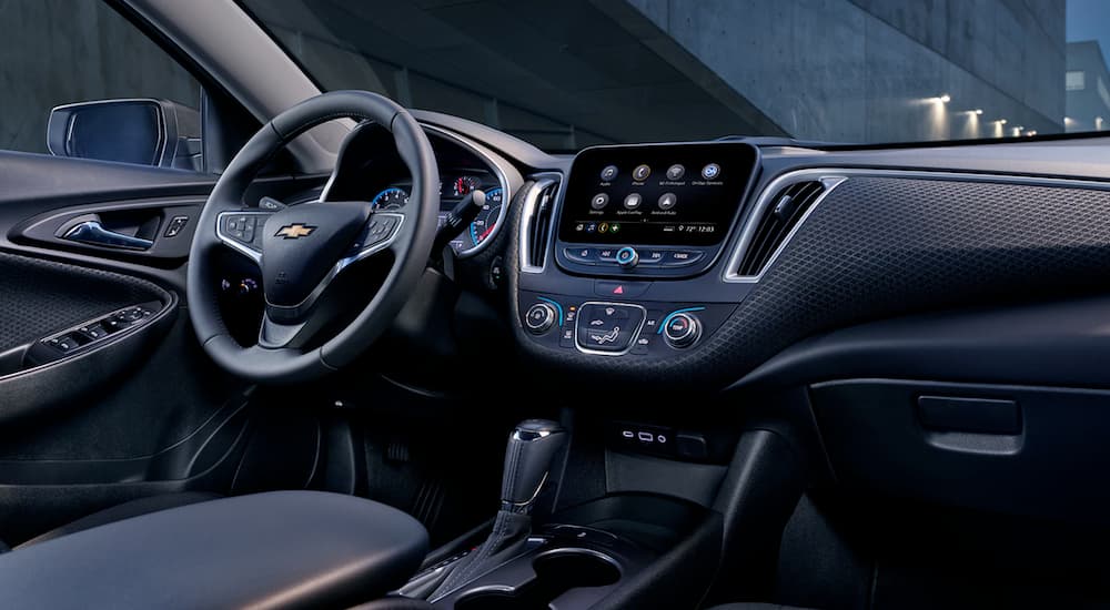 The black interior of a 2019 Chevy Malibu is shown from the passenger seat.