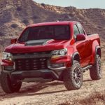 A red 2022 Chevy Colorado ZR2 is shown from the front at an angle in the desert after leaving a Chevy dealer near you.
